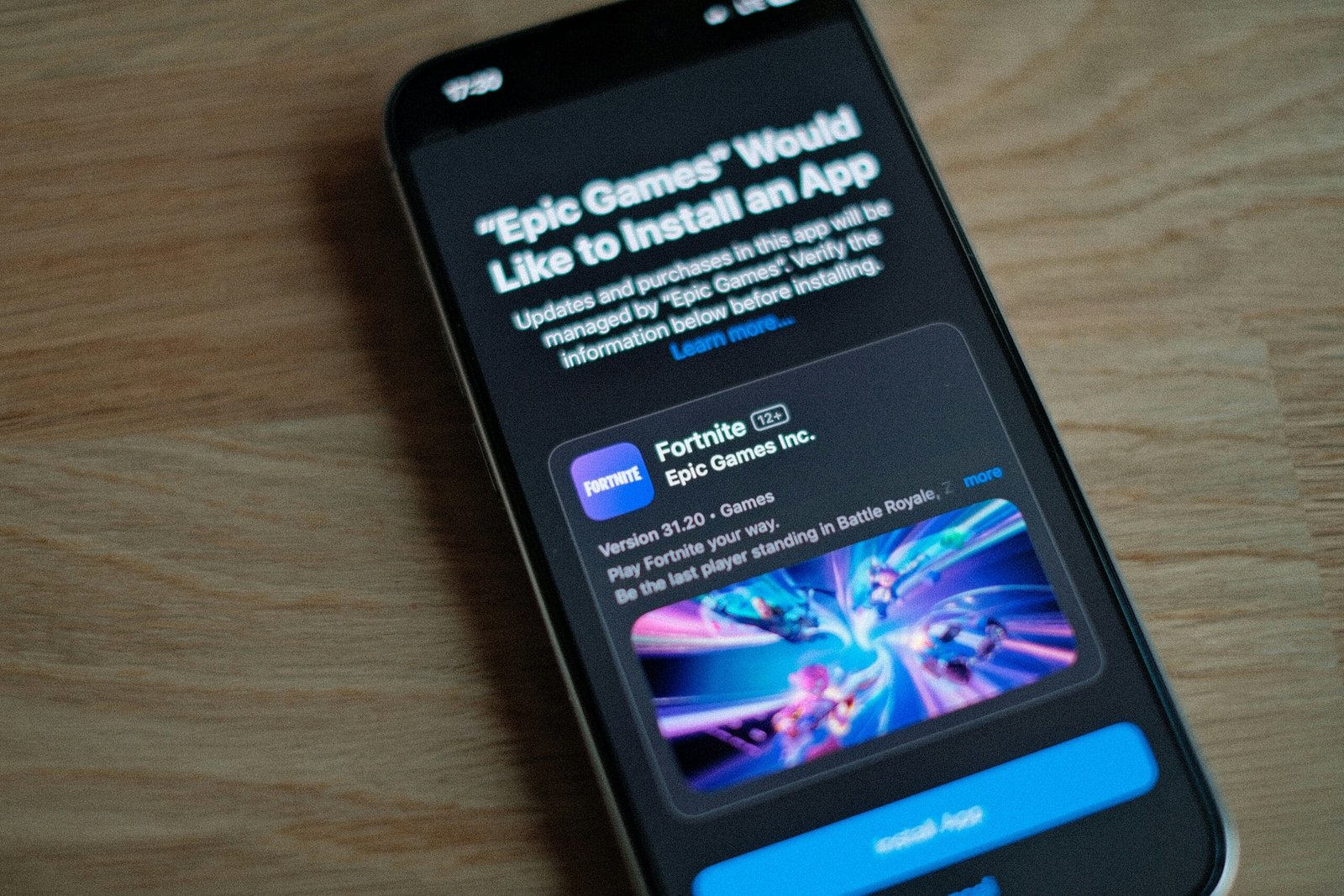 A cell phone sitting on top of a wooden table